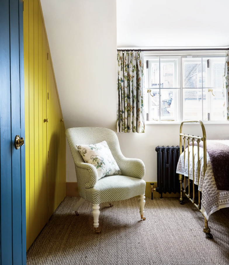 Charming yellow and blue bedroom with floral curtains